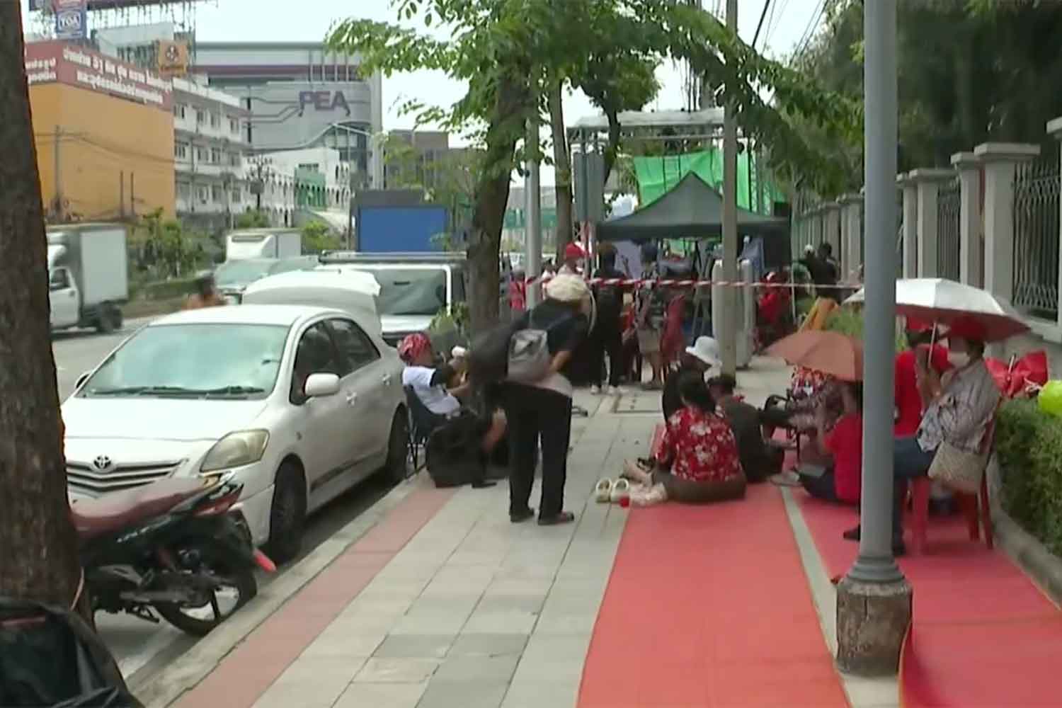 Red-shirt supporters gather outside Klong Prem Prison ahead of Thaksin's parole