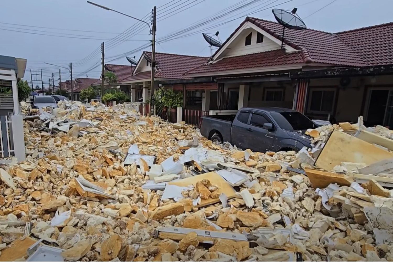 Recycled Waste Floods Chon Buri Housing Estate After Wall Collapse